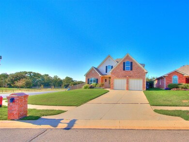 Traditional-style house featuring concrete driveway, brick siding, and an attached garage