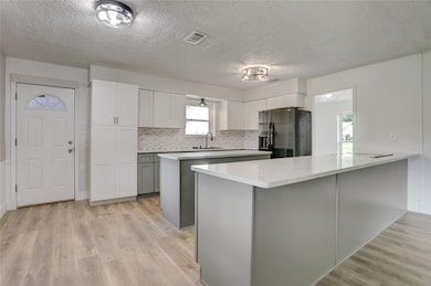 This kitchen features a generous island with sleek
