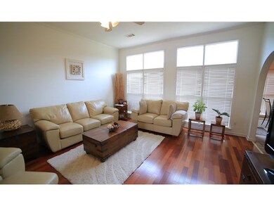 Gleaming Hardwood Floors and elegant Transom windo