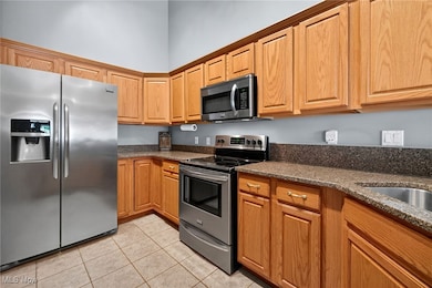 Kitchen with stainless steel appliances, wood cabinets and granite countertops