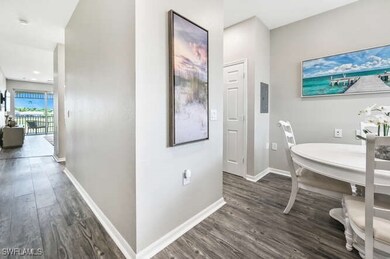 Corridor with baseboards and dark wood-style floors