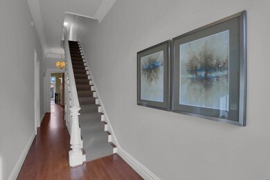 A lovely entry hall and staircase greet you upon a