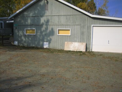 View of side of property with a garage