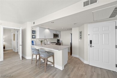 Kitchen featuring kitchen peninsula, appliances wi
