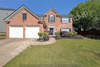 View of front of house with a garage, fence, concr