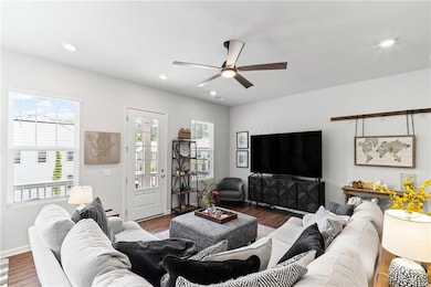 Living area featuring a ceiling fan, wood finished