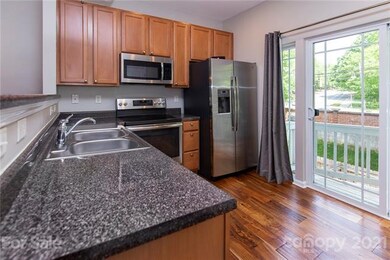 Kitchen has pretty cabinets and sliding door to ba