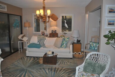 Tiled living room with a chandelier