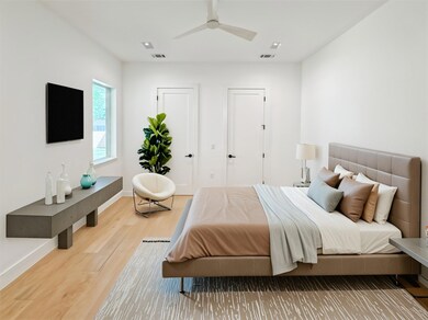 Bedroom with wood finished floors, baseboards, an