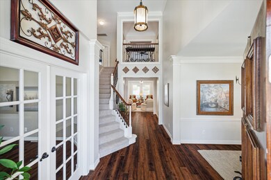 Entry with high ceilings and study to the left.  Throughout the downstairs is 2020 luxury vinyl plank flooring.