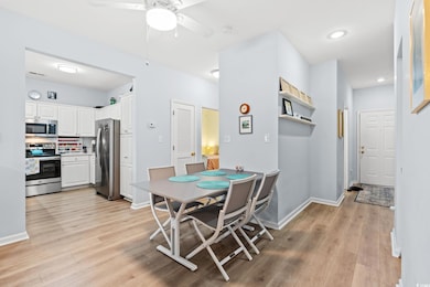 Dining room with light wood-style flooring, a ceiling fan, baseboards, and recessed lighting