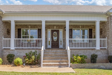 A lovely front porch welcomes you and your guests to sit down and have a chat!