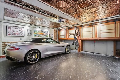 Custom garage with tin ceiling with track lighting & African Mahogany wood custom cabinets