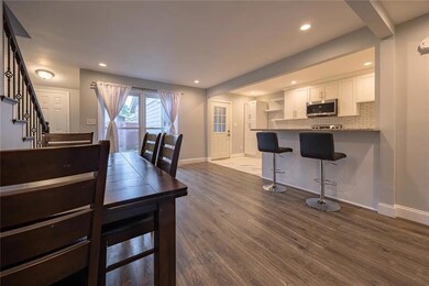 Dining area featuring stairs, dark wood-style floors, and recessed lighting