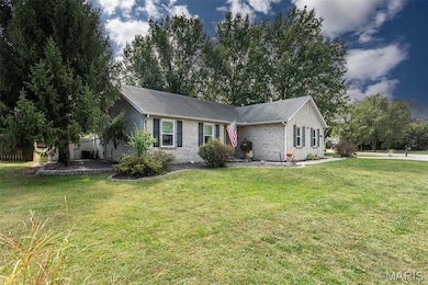 Single story home featuring a front yard, brick siding, and a shingled roof