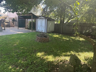 Fenced in back yard with storage shed