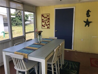 Screened-in side porch welcomes you as you enter t