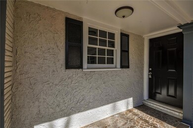 View of exterior entry with covered porch