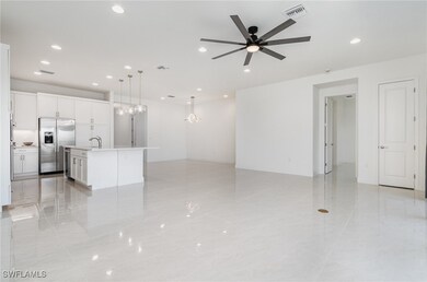 Unfurnished living room featuring a ceiling fan, r