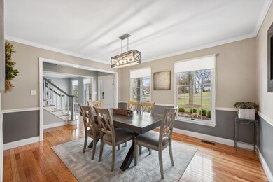 Formal Dining Room brightened by large front windows and window treatments which are found throughout the house.