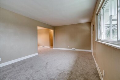 Large living room with new neutral carpet, base bo