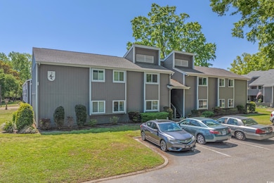View of building exterior with uncovered parking