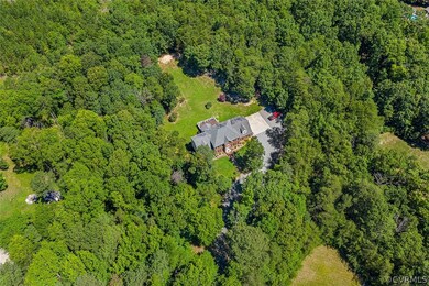 Private, serene lot with large cleared yard surrounded by trees.