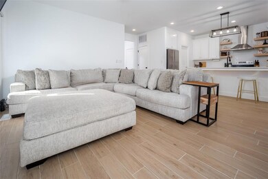 Living room featuring recessed lighting, visible vents, and light wood-style floors