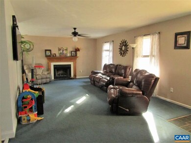 The spacious living room boasts a wood burning fir