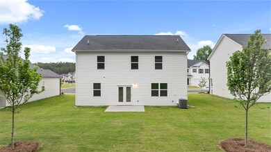 Back of house with a lawn, a patio area, and french doors