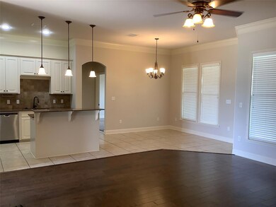 Kitchen featuring pendant lighting, light hardwood