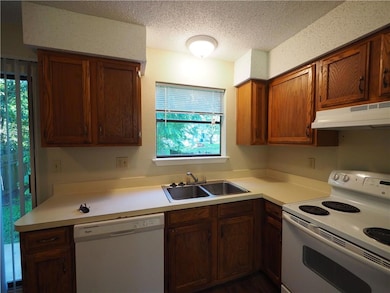 Kitchen with white appliances, under cabinet rang