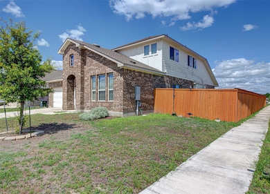 View of property exterior with brick siding, a ga