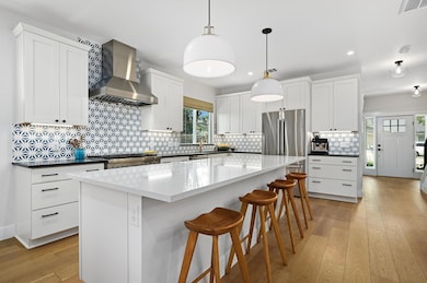 Kitchen featuring light wood-style floors, wall c