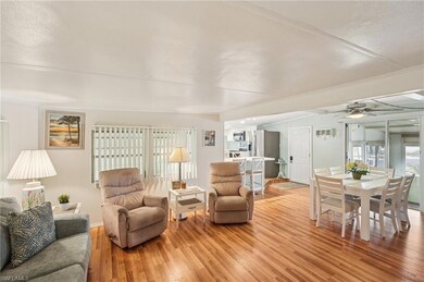 Living room featuring light wood-style flooring and a ceiling fan