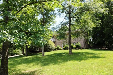 The house sits perched on a small hill and has lovely views of the large front yard.