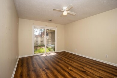 Empty room featuring baseboards, a ceiling fan, a 