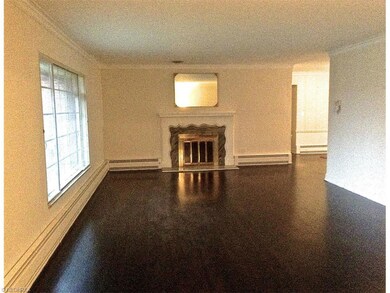 Elegant and spacious living room features hardwood
