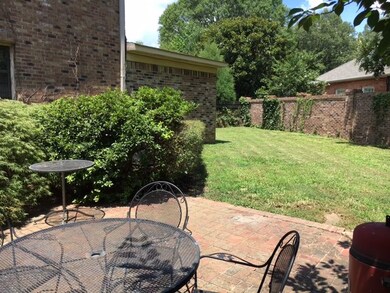 Lovely brick patio surrounded by pretty landscapin