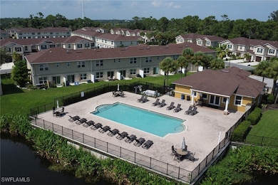View of pool with a lawn, a water view, and a pati