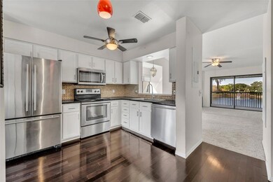 Kitchen with shaker cabinets, SS appliances and granite tile counter tops