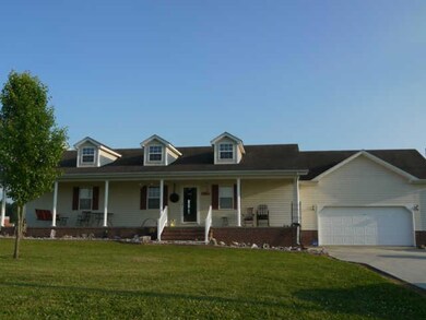 Covered front porch, two car garage, concrete drive 