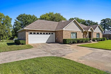 Ranch-style house featuring a front yard and a gar