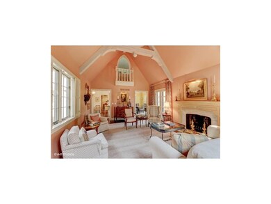 Great room with arched wooden beams, cozy fireplac