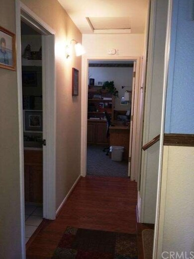 Hallway on main floor. Bathroom on left, stairs to