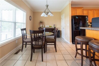 LARGE BREAKFAST ROOM WITH BREAKFAST BAR OVERLOOKS BEAUTIFULLY MAINTAINED YARD