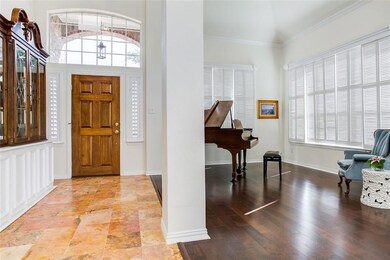 Beautiful bright Foyer with a rich dark travertine
