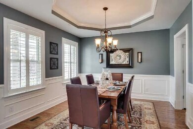 The current owners have tastefully decorated the formal dining room.  Note the plantation shutters that have been added.