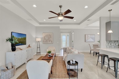 Family room with gorgeous coffered ceilings. Abundant natural light