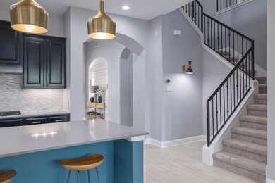 Kitchen featuring arched walkways, backsplash, a 